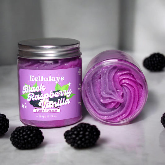 Two jars of Kellulays Black Raspberry Vanilla Body Polish, one upright and one open, showcasing its purple swirl texture. The packaging features a raspberry and vanilla design, with blackberries nearby.