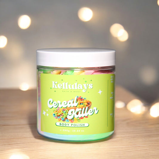 Jar of Kellulays ‘Cereal Killer’ body polish with a green label featuring a colorful cereal bowl image, set against a blurred background with glowing lights.