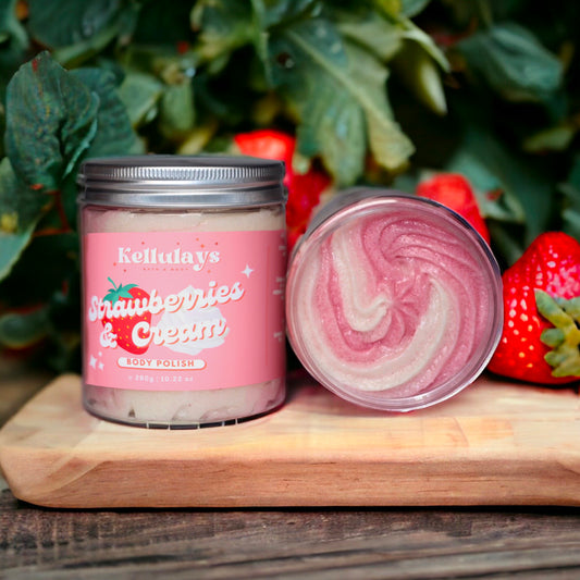 Jar of Kellulays Strawberries & Cream Body Polish with a pink and cream swirl, set on a wooden board with fresh strawberries in the background.