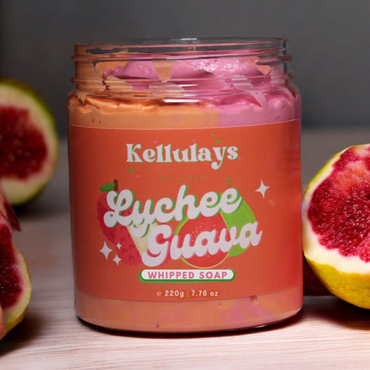 Close-up of a jar of Kellulays Lychee and Guava Whipped Soap, showcasing a vibrant orange and pink swirl. The handmade bath whip features a luxurious texture and is infused with nourishing cocoa and shea butters, designed to cleanse, moisturize, and rejuvenate the skin. The jar is labeled with the product name, highlighting its tropical lychee and guava scent.