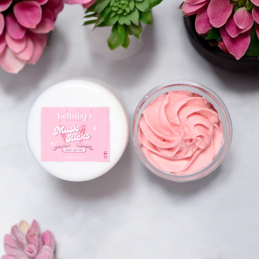 Mini sample jar of Kellulays whipped body butter with a pink swirl design, inspired by musk stick lollies, set against fun and vibrant pink succulents