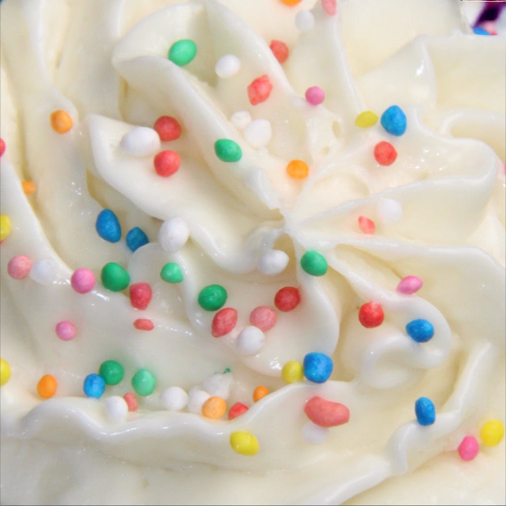 Close-up of Kellulays Funfetti Whipped Body Butter, showcasing the white whipped texture and vibrant colorful sprinkles on top, scented with 100s & 1000s fragrance.