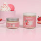 Two jars of Kellulay's Strawberries & Cream body butter on a pink background with strawberries and whipped cream.