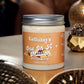 A jar of Kellulays One In A Million Whipped Soap with an orange label displaying the product name in elegant white script. The jar, filled with creamy soap, has a silver lid and is set on a wooden surface surrounded by decorative gold elements, creating a luxurious and sophisticated ambiance."
