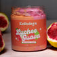 Close-up of a jar of Kellulays Lychee and Guava Whipped Soap, showcasing a vibrant orange and pink swirl. The handmade bath whip features a luxurious texture and is infused with nourishing cocoa and shea butters, designed to cleanse, moisturize, and rejuvenate the skin. The jar is labeled with the product name, highlighting its tropical lychee and guava scent.