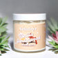 Image of a jar of Kellulays Bath & Body Vanilla Sandalwood Whipped Soap. The jar is labeled with a beige-colored sticker featuring the product name 'Vanilla Sandalwood' in bold, stylized white font with illustrations of vanilla pods and sandalwood pieces. The jar contains 220g (7.76 oz) of whipped soap, with a white lid. The background includes soft-focus green and pink succulents, adding a natural aesthetic to the presentation.